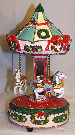 MUSICAL HORSE CAROUSEL PLAYS WHITE CHRISTMAS 
MEASURES 5 3/4" X 5 3/4" X 10 3/8"