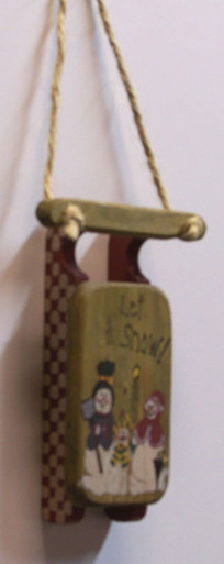 SMALL WOODEN SLED DECORATION "LET IT SNOW"  
MEASURES 3 1/2" X 7/8" X 8 3/8"