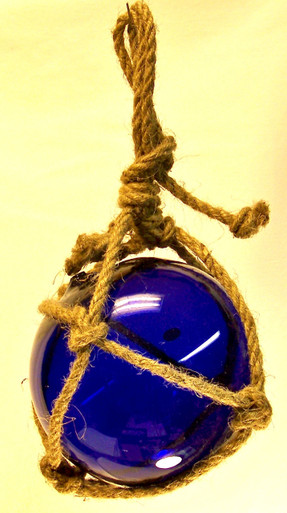 SMALL DARK BLUE GLASS FLOAT
 MEASURES 5" X 5" X 10" WITH ROPE
