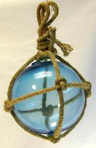 SMALL LIGHT BLUE GLASS FLOAT 
MEASURES 5" X 5" X 10" WITH ROPE