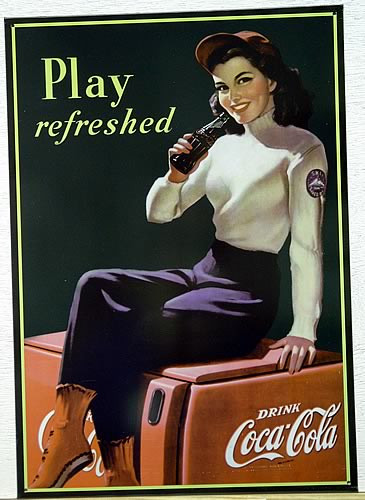 Photo of COKE COOLER GIRL SITTING ON AN OLD COCA-COLA COOLER IS JUST OFF THE SKI SLOPES LOOKING FOR REFRESHMENT. NOSTALGIC SIGN DATES TO AROUND THE 40'S