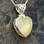 Ornate butterscotch baltic amber and sterling silver filigree love heart pendant