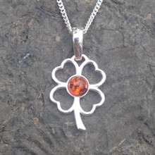 Contemporary sterling silver four leaf clover pendant with cognac amber cabochon