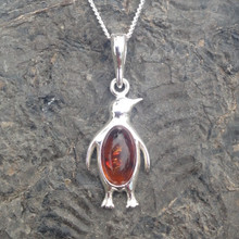 Contemporary natural cognac amber and sterling silver penguin pendant