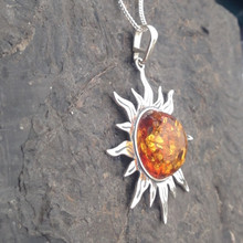 Large sterling silver solar pendant with shiny cognac amber cabochon