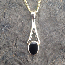 9ct gold small wishbone pendant set with Whitby Jet stone on gold curb chain