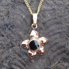9ct gold flower pendant with round hand carved Whitby Jet stone