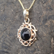9ct gold frill and bead circular pendant with round hand cut Whitby Jet cabochon