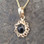Hand crafted black and gold flower pendant