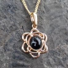 9ct gold open flower pendant with round Whitby Jet cabochon on gold chain