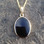 Large oval Whitby Jet pendant with 9ct gold 18 inch curb chain