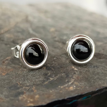 Modern round sterling silver stud earrings with Whitby Jet cabochons and a wide silver edge