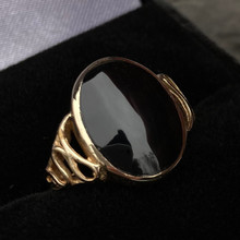 Ladies 9 carat gold fancy ring with hand cut shiny oval Whitby Jet stone