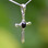 Rounded Whitby Jet and sterling silver cross pendant