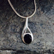 Contemporary asymmetrical sterling silver necklace with oval Whitby Jet stone