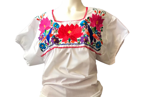 Puebla is a  white blouse embroidered of floral designs in bright colors. 