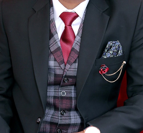 black notch lapel suit with purple check vest and red polka dot tie