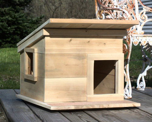 Outdoor Feral Cat Shelter House standard features include a roof overhang, side window and front door with grit strip on deck. 