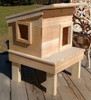 Single outdoor feral cat shelter house shown on OPTIONAL 12" standard stand
