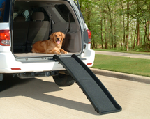 Ultra-Light Bi-Fold Dog Ramp being used to access the cargo area of an SUV