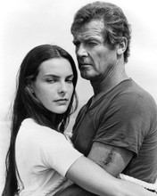 This is an image of Prints & Posters of Roger Moore and Carole Bouquet 104593