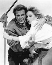 This is an image of Prints & Posters of Roger Moore and Tanya Roberts 104656