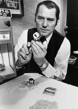 Robert Shaw examines diamond under magnifying glass 1975 Diamonds 5x7 inch photo