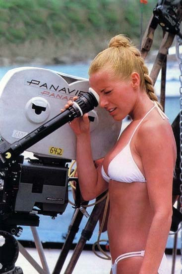 Cheryl Ladd in white bikini looks into camera lens on set