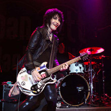 Joan Jett plays guitar in concert wearing leather outfit 12x12 photo