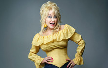 Dolly Parton classic smiling pose in yellow top hands on hips 12x18 poster