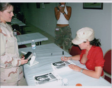 Alyssa Milano in revealing open shirt signs autograph for marine candid 8x10