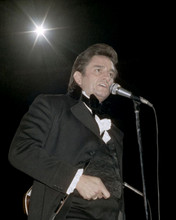 Johnny Cash in bow tie & frock coat on stage 1969 singing into mike 8x10 photo