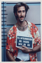 Nicolas Cage holding arrest sign being booked 8x10 photo 1987 Raising Arizona