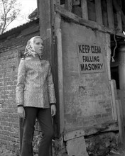 Diana Rigg wears headscarf standing by abandoned building The Avengers TV 8x10