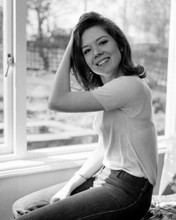 Diana Rigg smiling with hand in hair sitting in window 8x10 photo