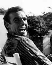 Sean Connery early 1960's seated pose laughing over shoulder 8x10 inch photo