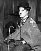 Charles Chaplin dressed as The Little Tramp holding his cane 8x10 inch photo
