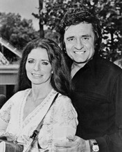 Johnny Cash poses with June Carter Cash with guitar 1978 8x10 inch photo