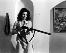 Edwige Fenech in open shirt pointing large rifle 8x10 inch photo