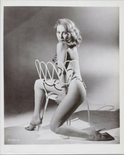 Angelique Pettyjohn original 8x0 publicity photo sits wearing bikini on chair
