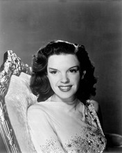 Judy Garland smiling 1940's studio portrait seated on chair 8x10 inch photo