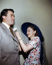 Gregory Peck 1940's era looking dapper in grey suit getting flower pinned 8x10