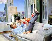 Steve McQueen relaxes on sofa with legs in air 8x10 inch photo