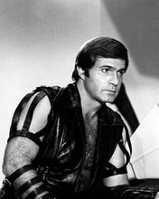 Buck Rogers in the 25th Century Gil Gerard wears black vest barechest 8x10 photo