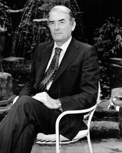 Gregory Peck looks debonair in suit seated in chair circa 1980's 8x10 inch photo