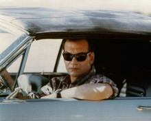 Patrick Swayze at wheel of car wearing shades 8x10 inch photo