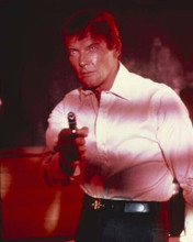 Roger Moore points gun with red light on him Man With The Golden Gun 8x10 photo