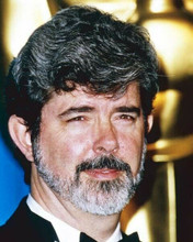 George Lucas in tuxedo standing by Oscar statue 8x10 inch photo