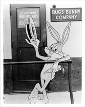 Bugs Bunny holding his carrot tipping his hat outside Bugs Bunny Company 8x10