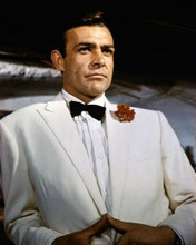 Sean Connery suave as bond in his white tuxedo & red flower in lapel Goldfinger